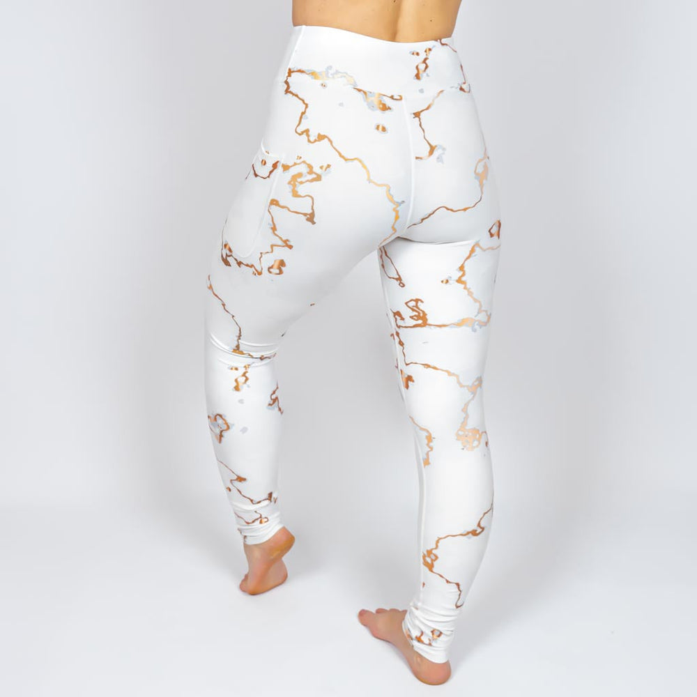 Kvinde i højtaljede mønstrede leggings. Tights har lommer på begge sider. Meget elastiske og squat proof.