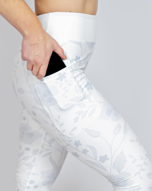 Kvinde i højtaljede mønstrede leggings. Tights har lommer på begge sider. Meget elastiske og squat proof.